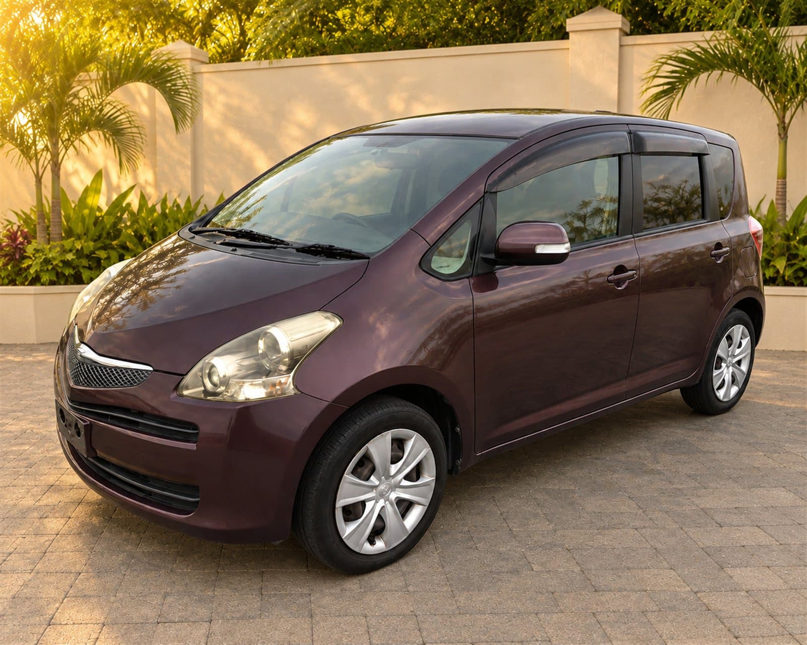 Front three-quarter view of the burgundy Toyota Ractis