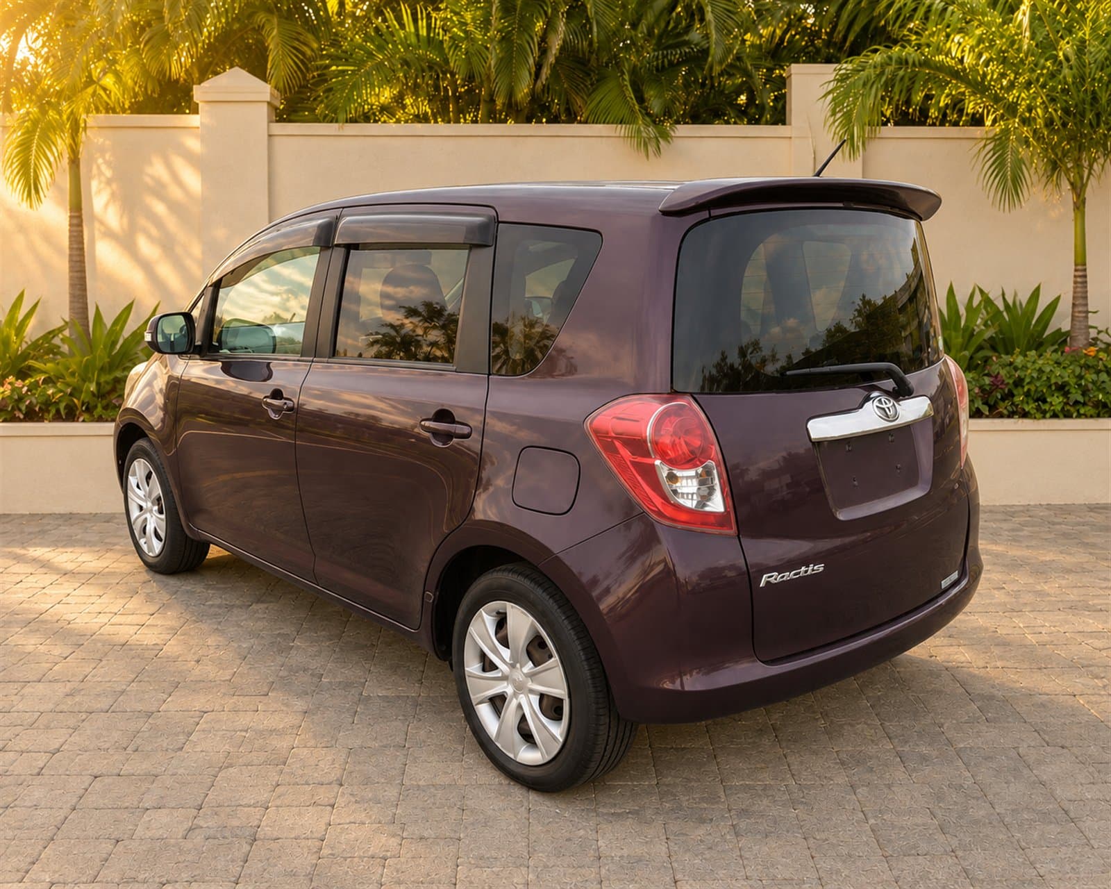 Rear three-quarter view of the burgundy Toyota Ractis