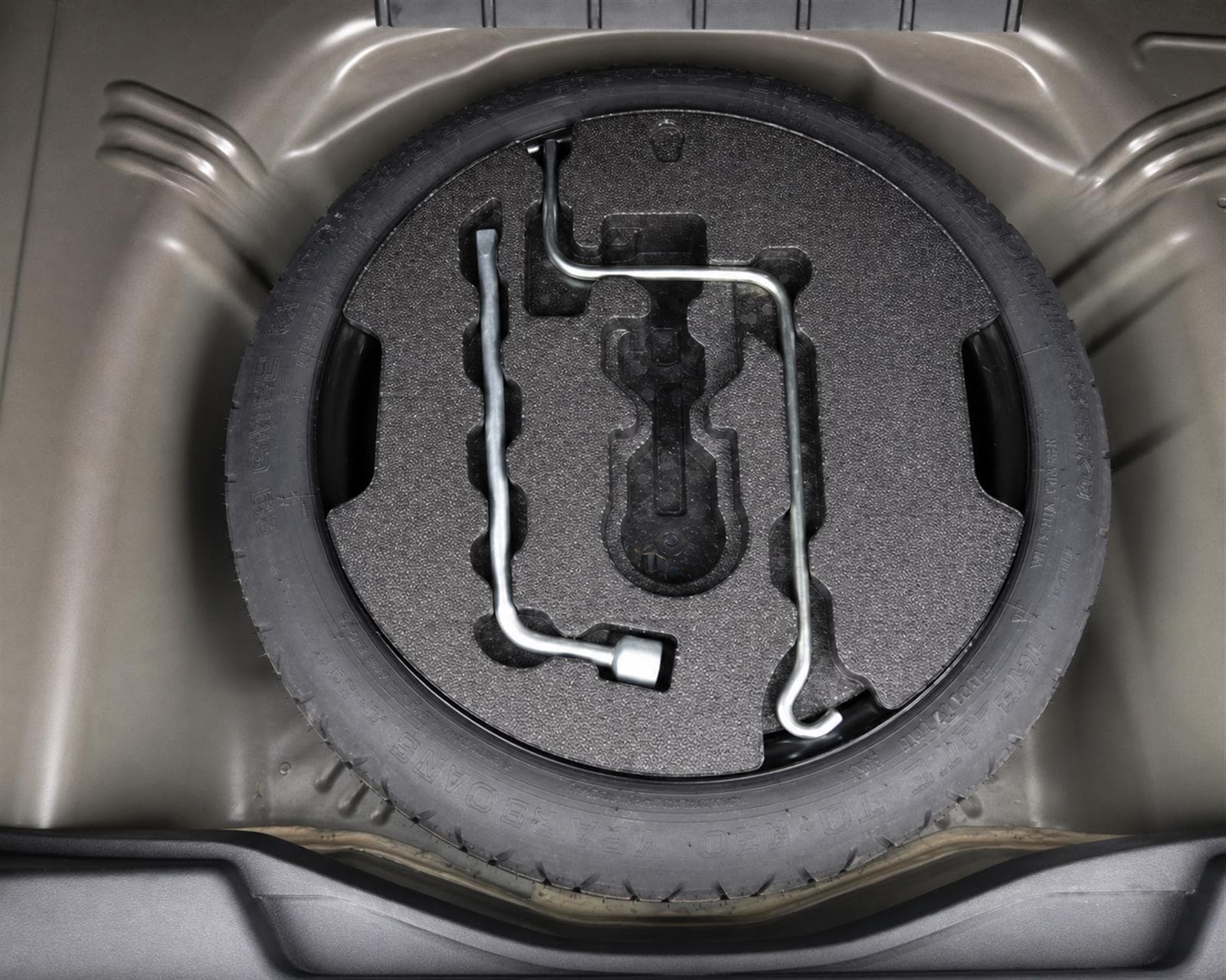 Spare wheel, jack and tools beneath the Toyota Ractis boot floor